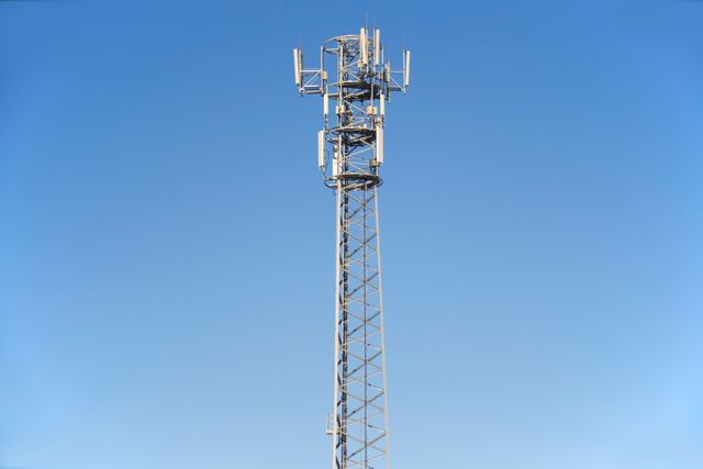 Cellular tower against a clear blue sky